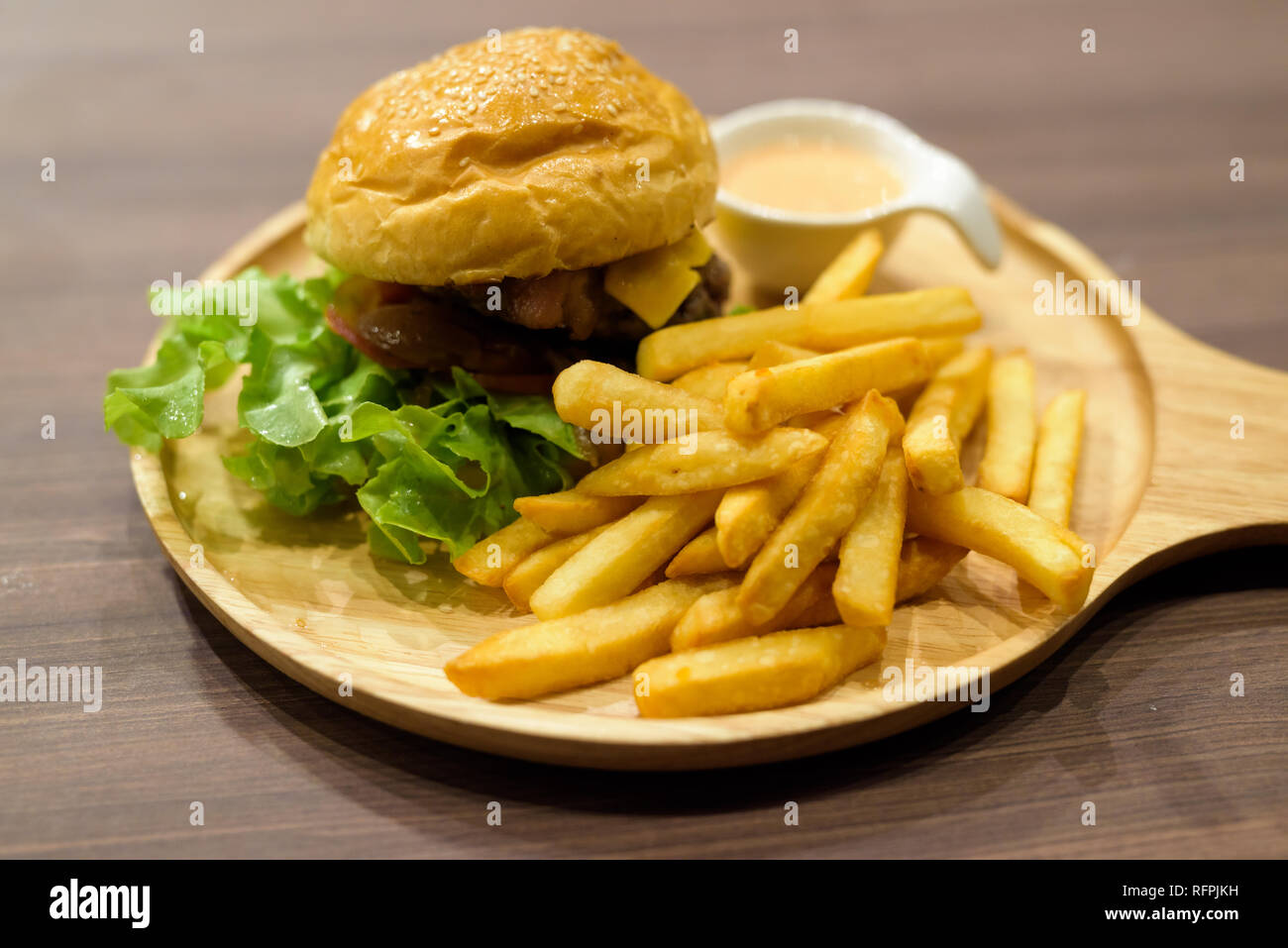 Cheeseburger And French Fries Served On Wooden Table Stock Photo