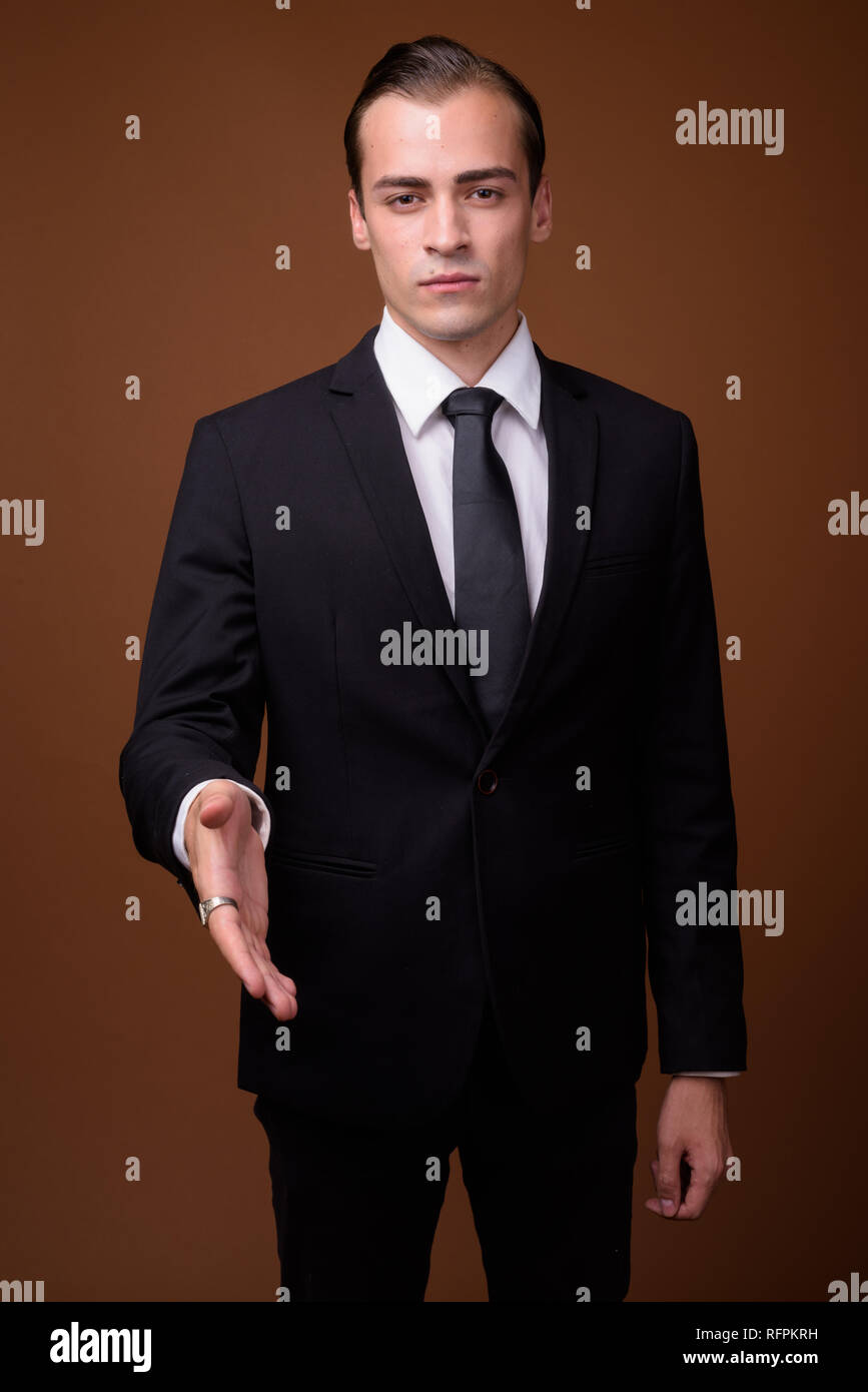 Portrait of young Caucasian businessman giving handshake Stock Photo