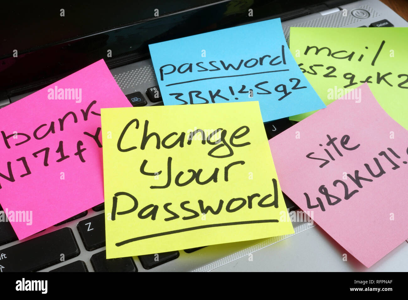 Change your password. Laptop with pieces of paper. Stock Photo