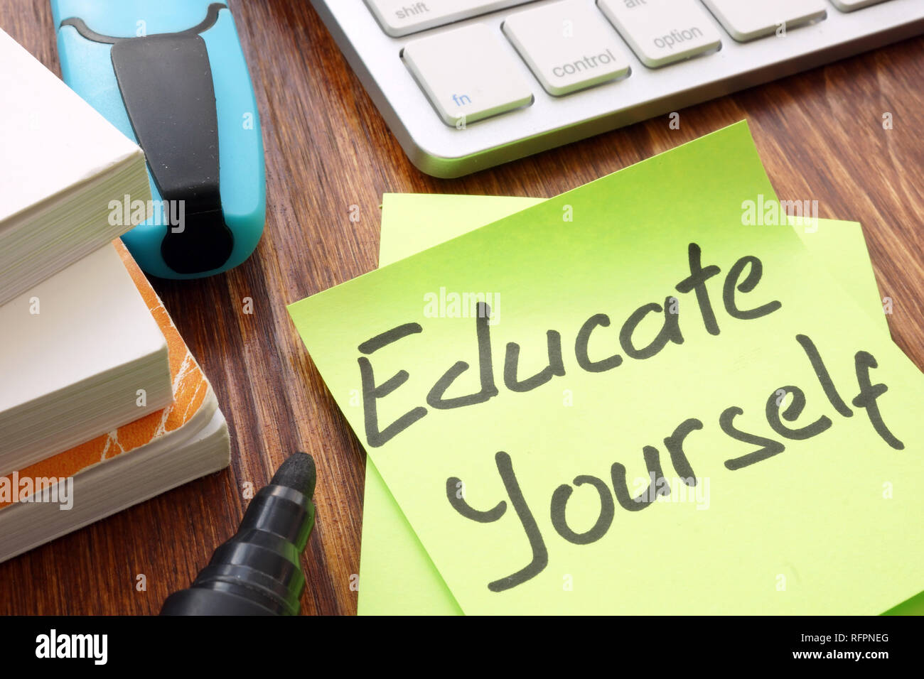 Lifelong learning concept. Sign educate yourself on a memo. Stock Photo