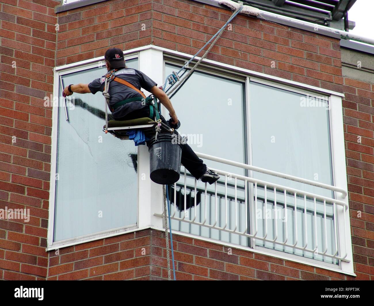 USA, United States of America : Window cleaner, abseiling from the roof to each floor. Stock Photo