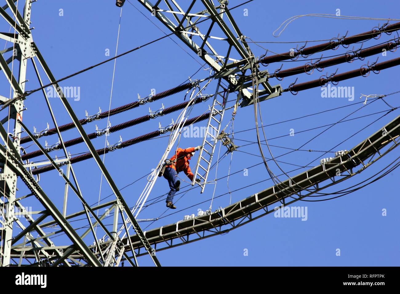 DEU, Germany : Worker on a high-voltage transmission line. Stock Photo