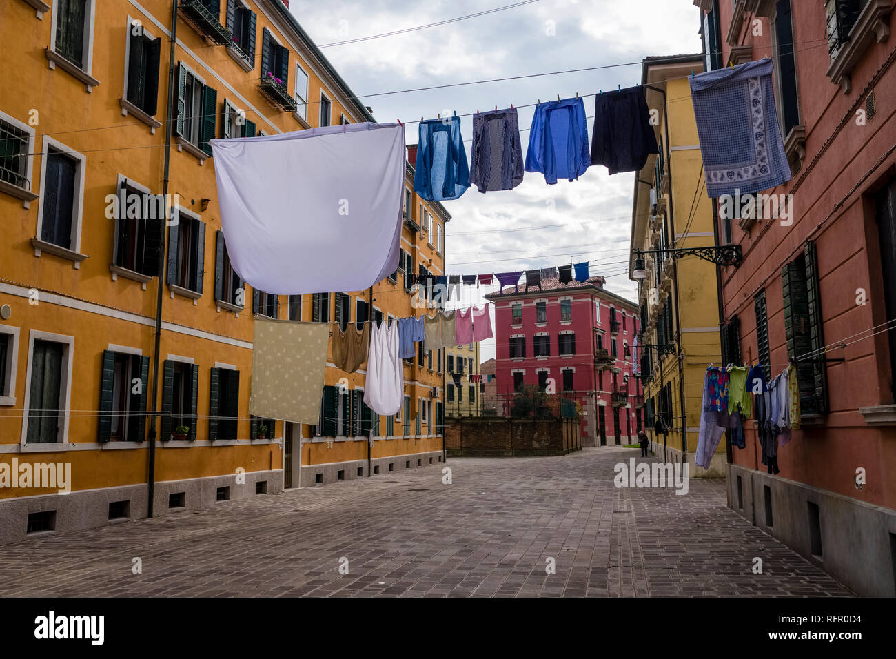Narrow streets leading through the ailing brick houses of the so-called 'Floating city', laundry is put up on washing lines Stock Photo