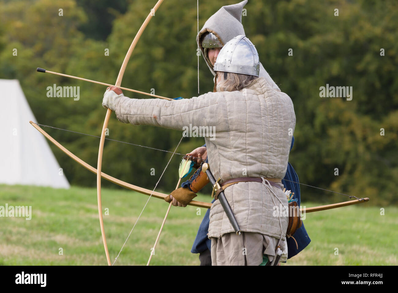 Medieval re-enactors dressed as archers of the 12th century equiped with a long bows re-enacting combat of the period Stock Photo