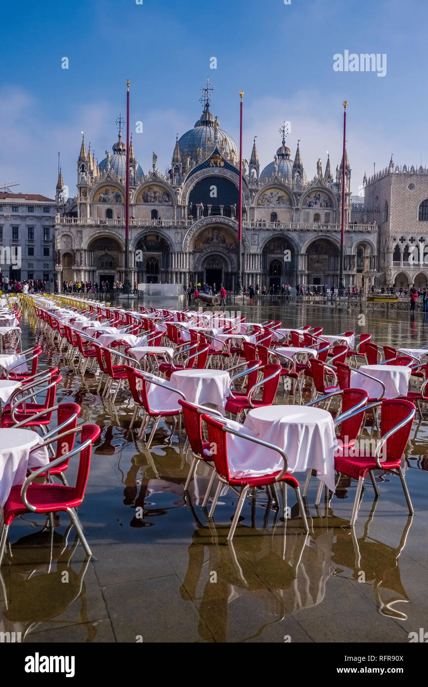 San Marco Square, Piazza San Marco, with empty tables and chairs of a restaurant, flooded during the Acqua alta Stock Photo
