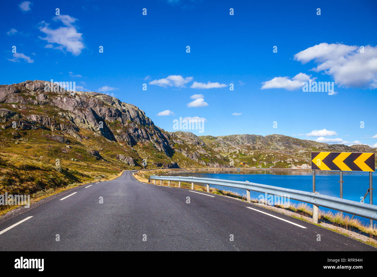 Scenic mountain road along a lake, VestAgder county, Norway