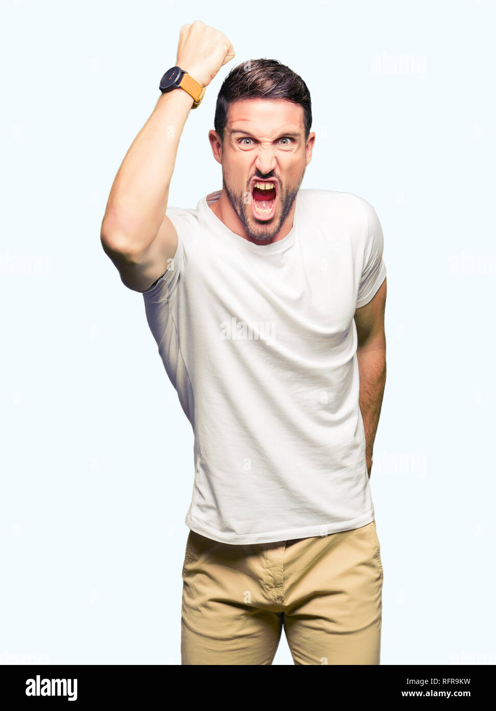 Guy Raging Stock Handsome man wearing casual white t-shirt angry and mad raising fist ...