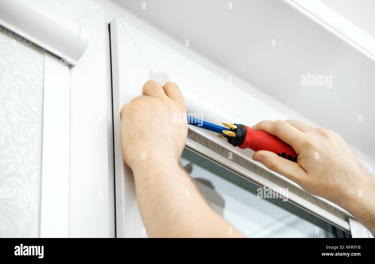 Man installing cassette roller blinds on windows Stock Photo