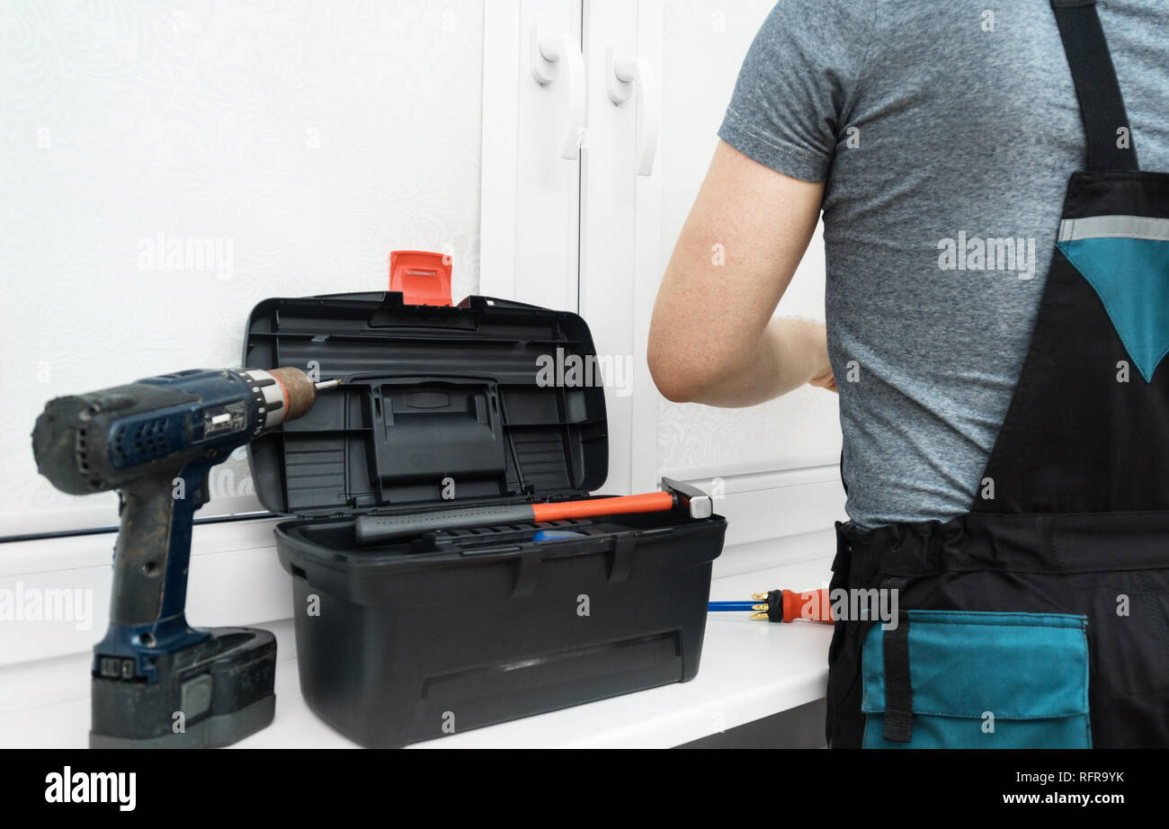 Man installing cassette roller blinds on windows Stock Photo