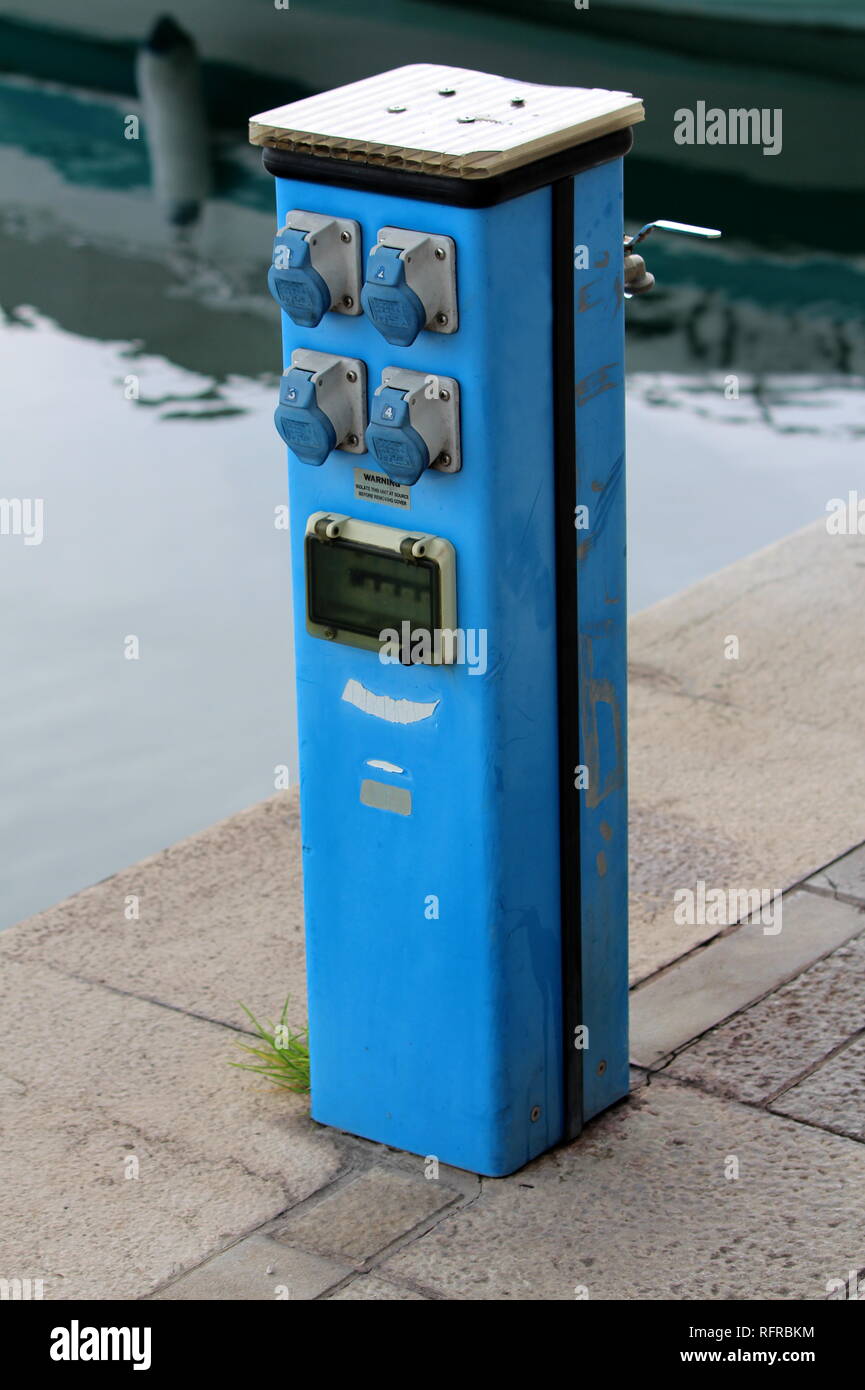 Outdoor electrical outlets with safety switches mounted on blue metal