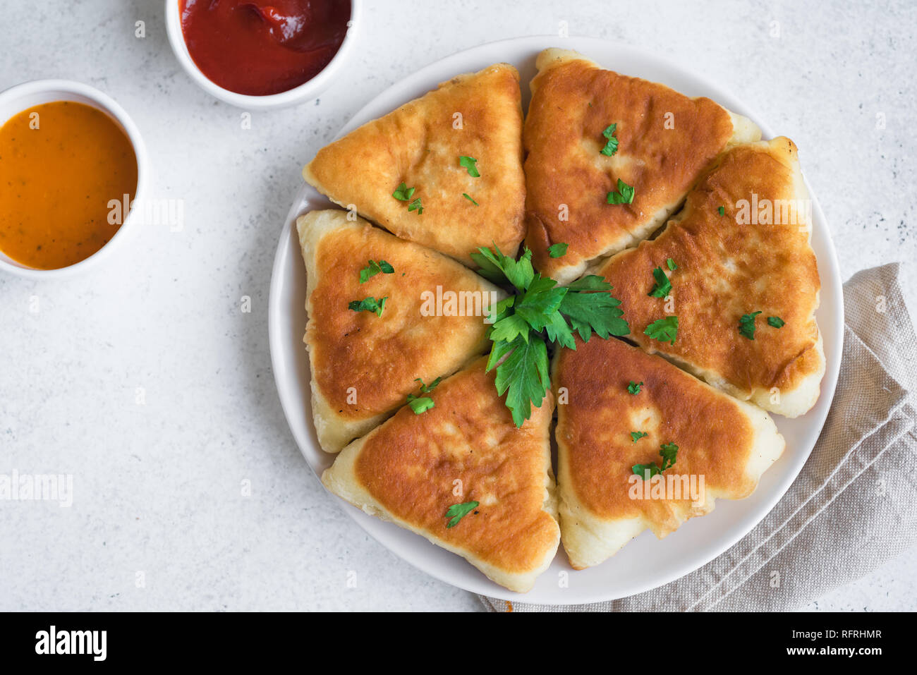 Deep fried meat pies with sauces, samsa, samosas, echpochmak
