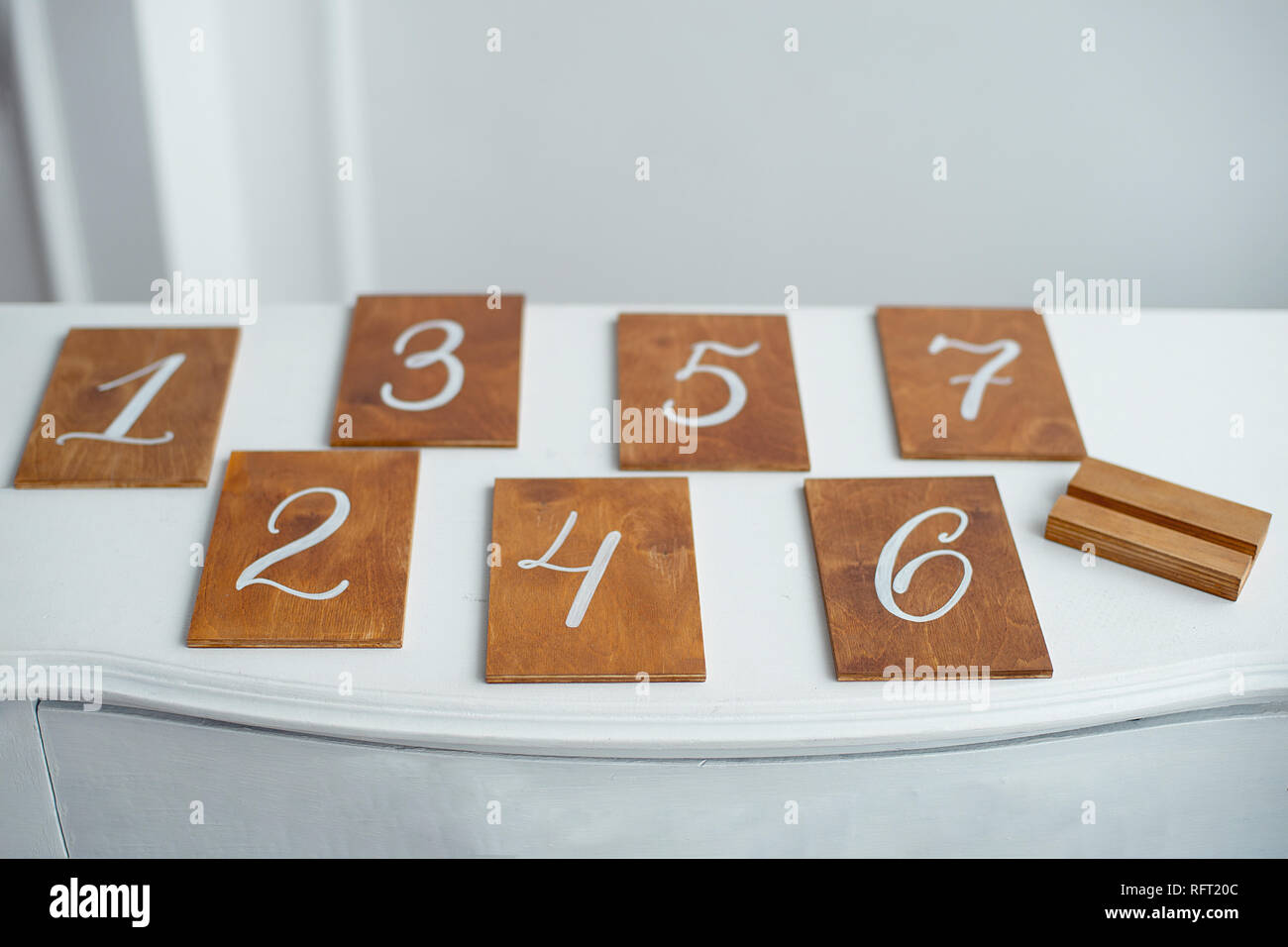 Vintage rectangular shaped wooden number buttons on a white wooden ...