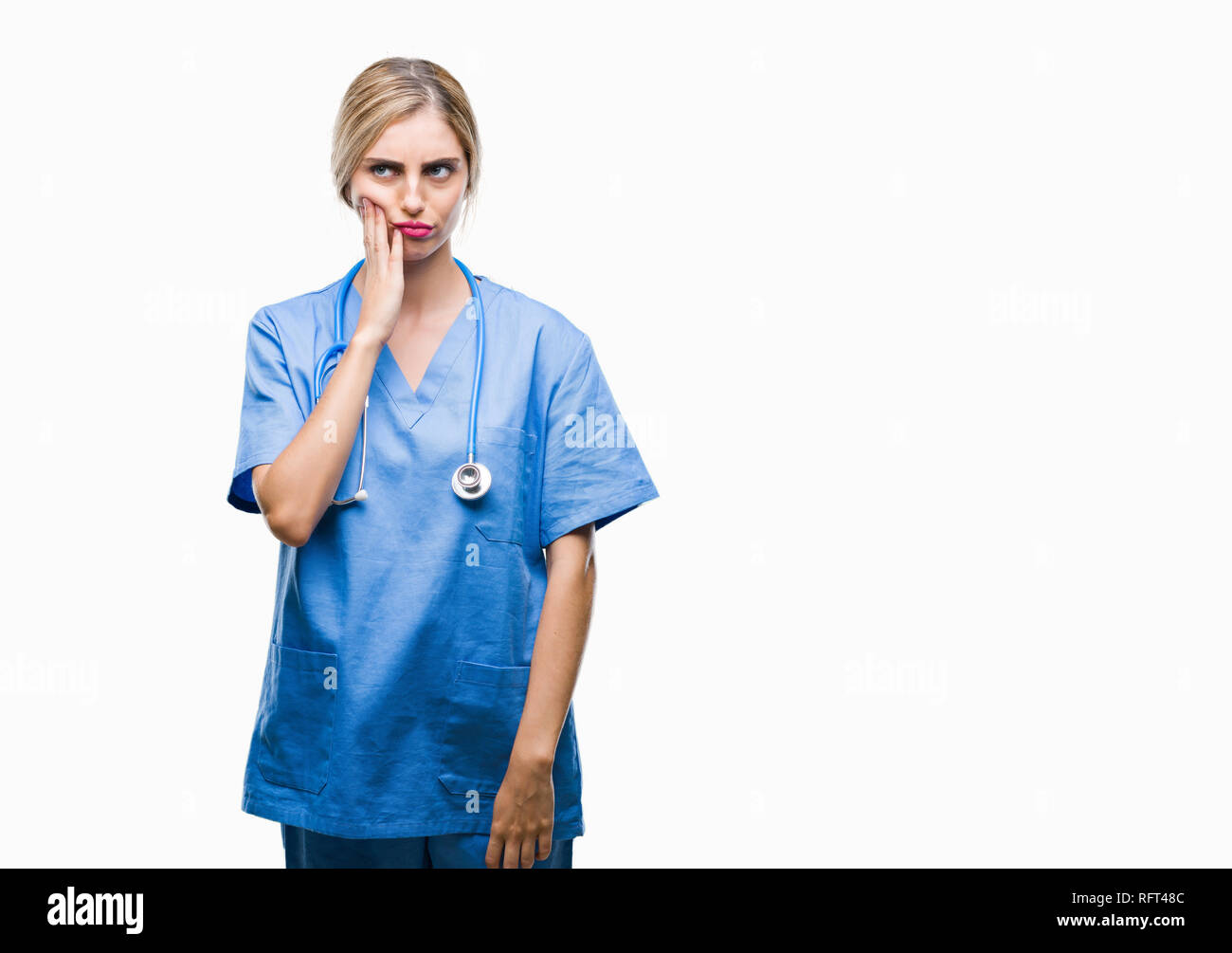 Young beautiful blonde doctor surgeon nurse woman over isolated background thinking looking tired and bored with depression problems with crossed arms Stock Photo