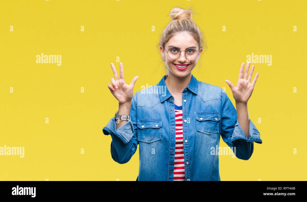 Young beautiful blonde woman wearing glasses over isolated background showing and pointing up with fingers number eight while smiling confident and ha Stock Photo