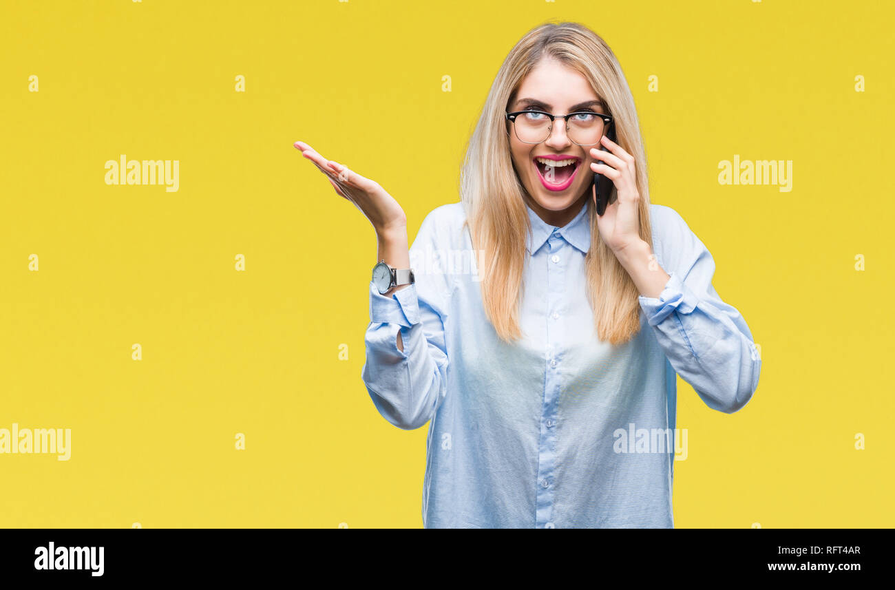 Young beautiful blonde business woman calling on smartphone over ...