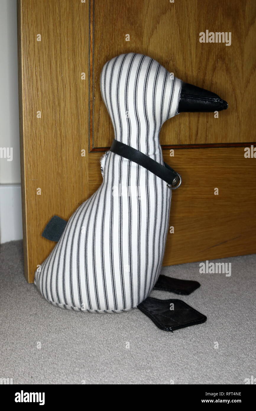 a striped door stop in the shape of a duck Stock Photo