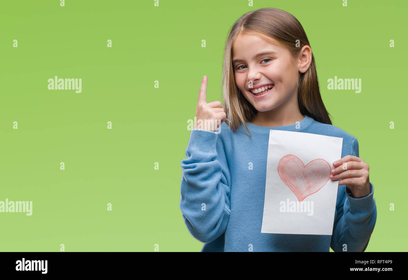 Young beautiful girl giving mother father day card with red heart over isolated background very happy pointing with hand and finger to the side Stock Photo