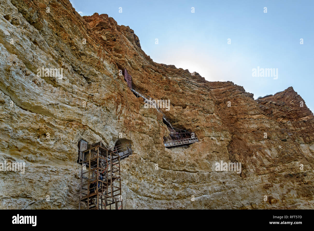 Old iron staircase in the rock Stock Photo