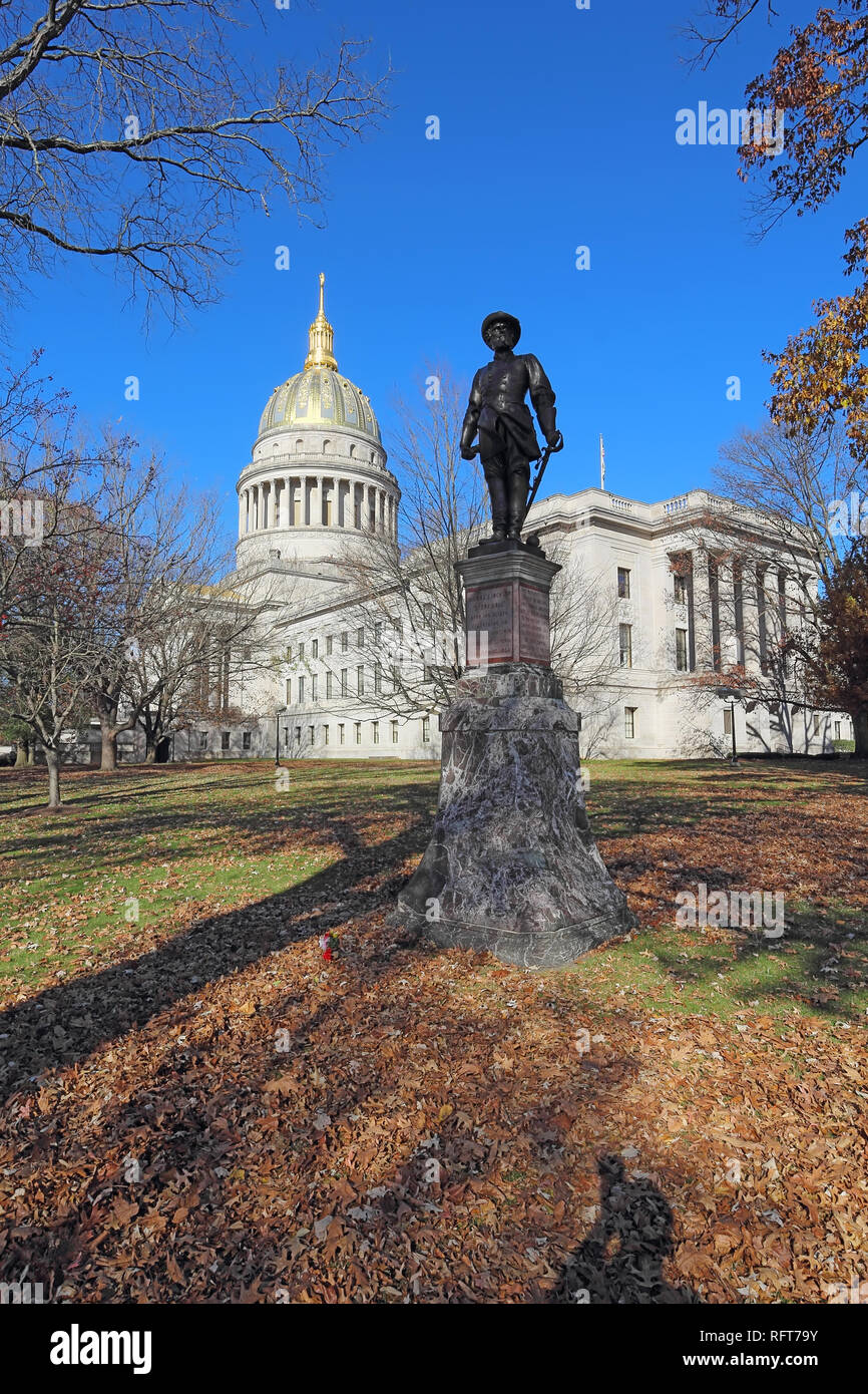 Historical statue and dome of the West Virginia capitol building in Charleston against a blight blue autumn sky vertical Stock Photo