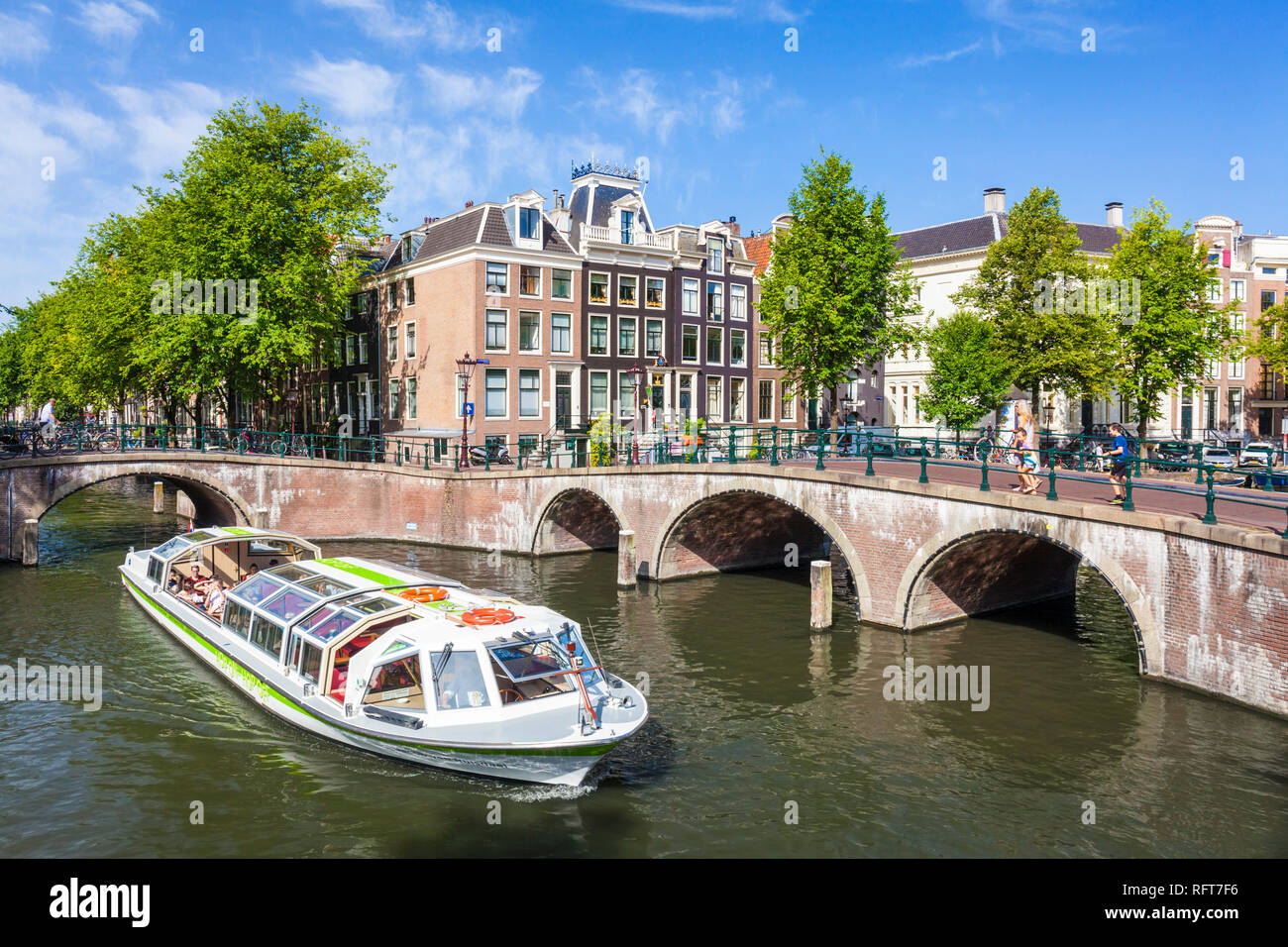 Canal tour boat and bridges at the junction of Leidsegracht Canal and Keizergracht Canal, Amsterdam, North Holland, Netherlands, Europe Stock Photo
