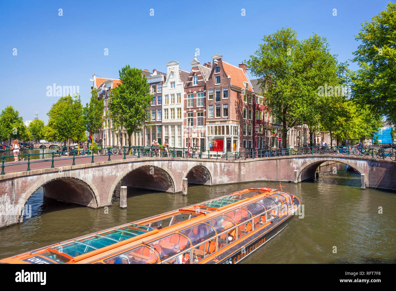 Canal tour boat and bridges at the junction of Leidsegracht Canal and Keizergracht Canal, Amsterdam, North Holland, Netherlands, Europe Stock Photo