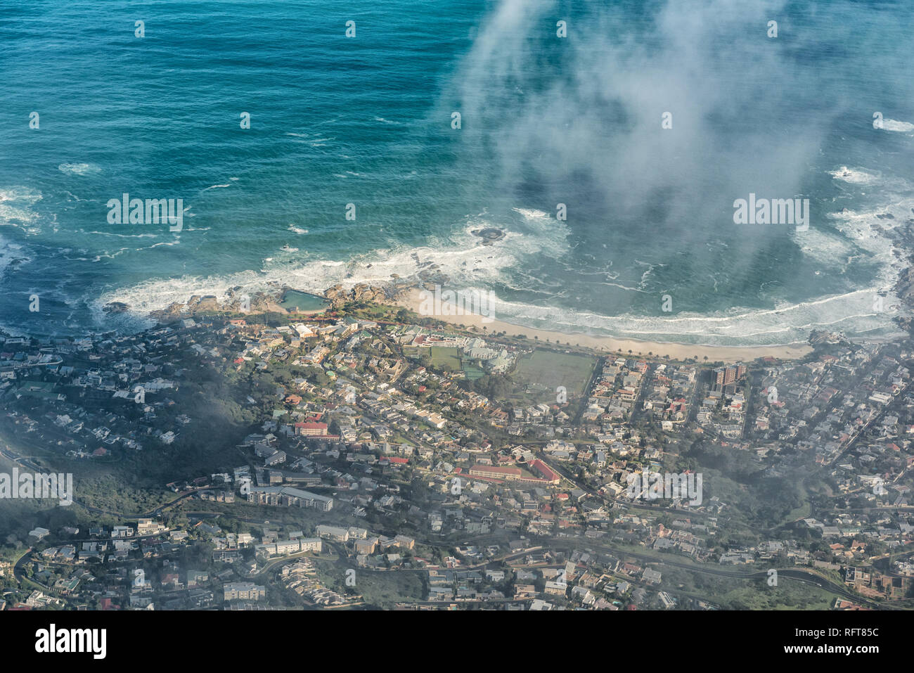 CAPE TOWN, SOUTH AFRICA, AUGUST 17, 2018: Camps Bay in Cape Town as seen through the clouds from the upper cable station on Table Mountain Stock Photo