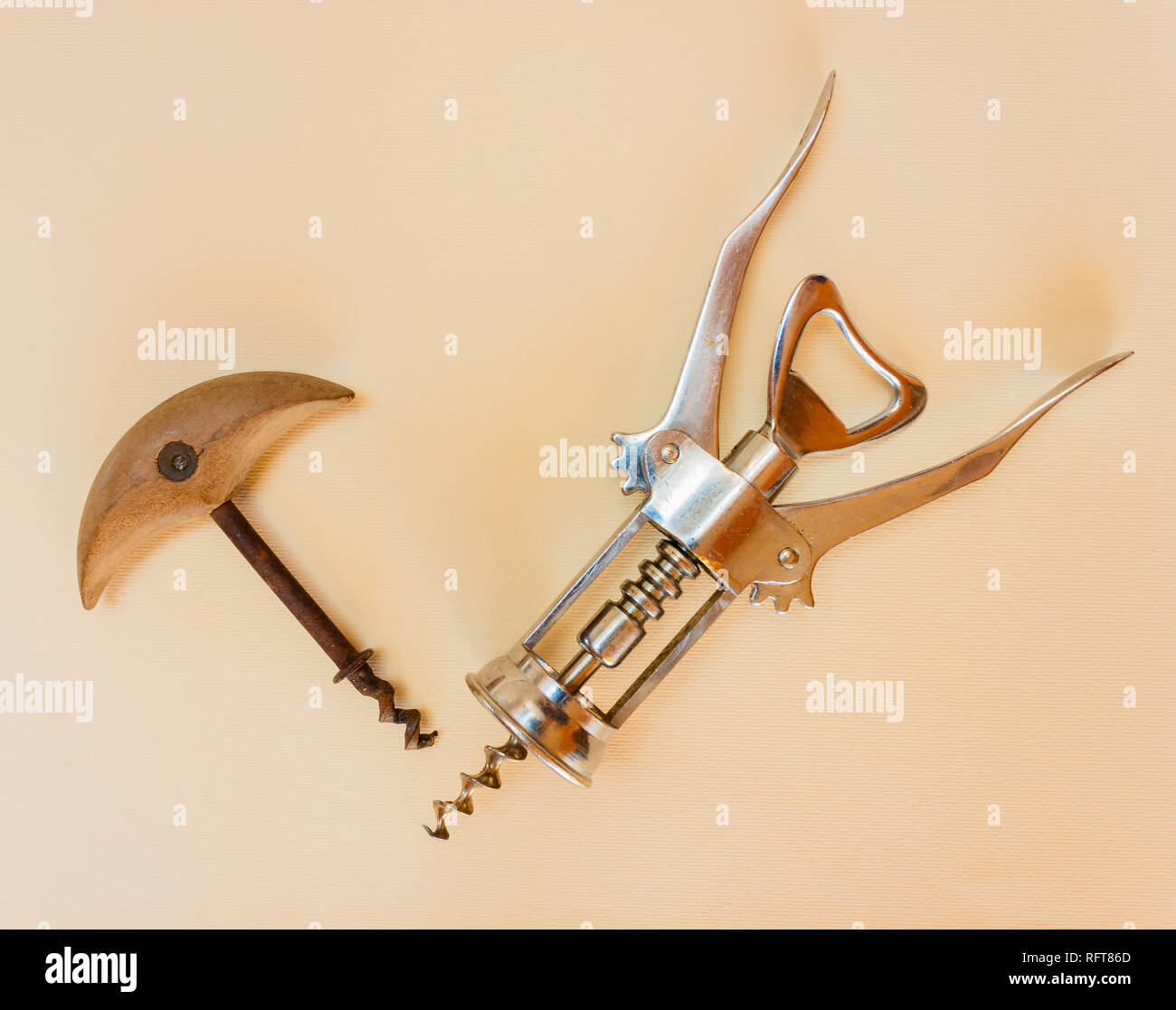 two corkscrews from different eras, one in metal and the other in wood and iron Stock Photo
