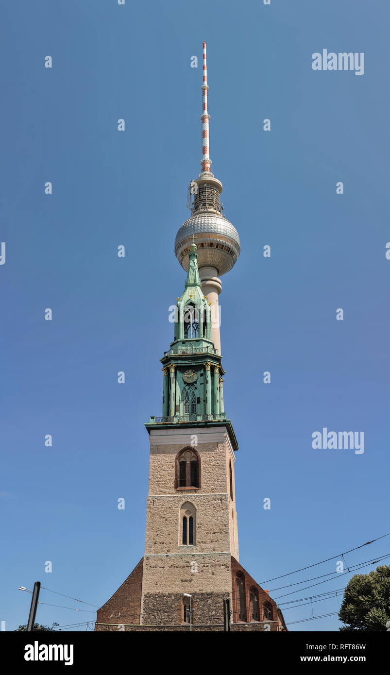 Berlin Tv Tower or Fernsehturm and St. Mary Church or Marienkirche, Germany. Vertical panorama. Stock Photo