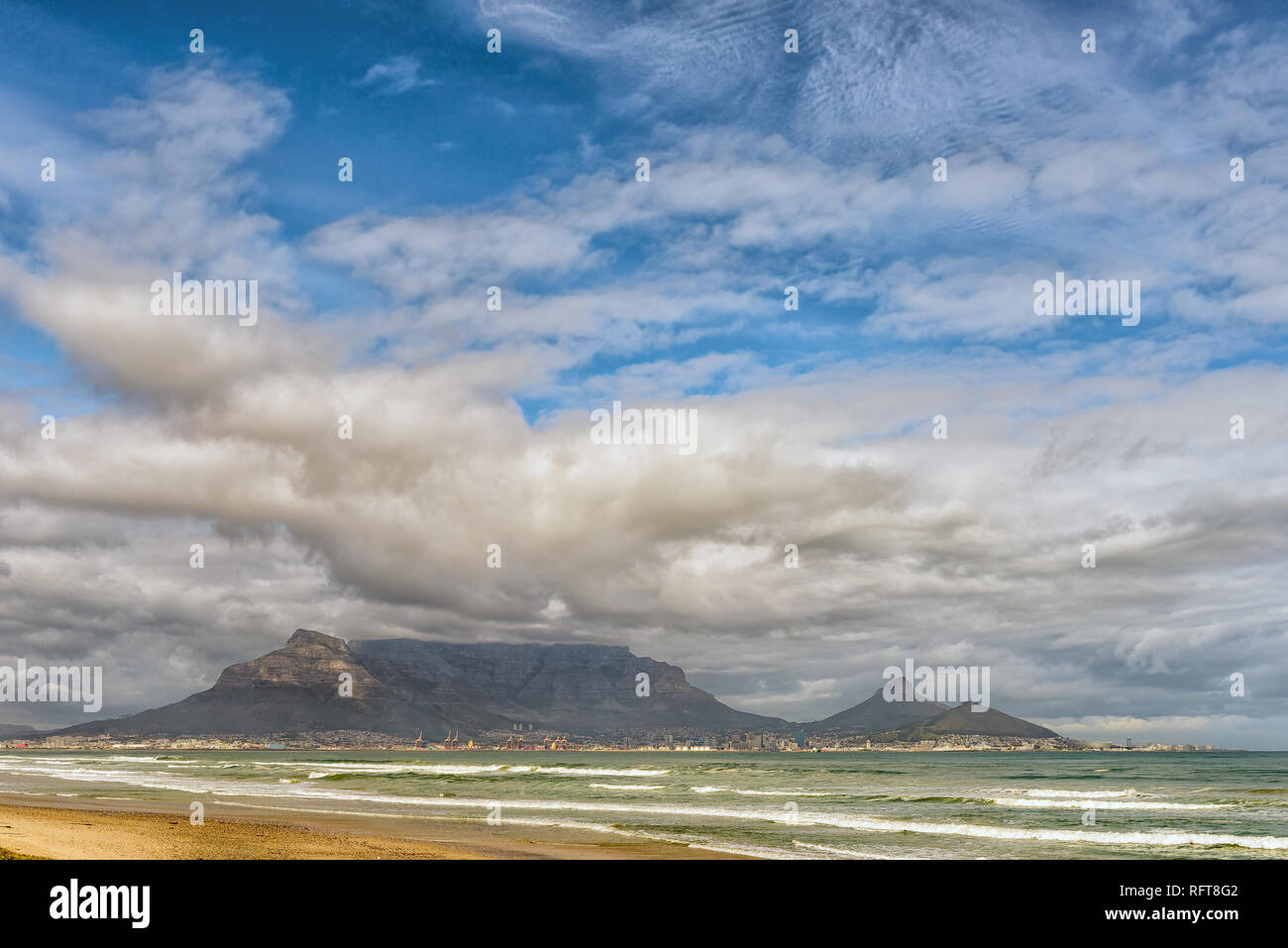 The Cape Town Central Business District and Table Mountain as seen across Table Bay from Dolphin Beach Stock Photo