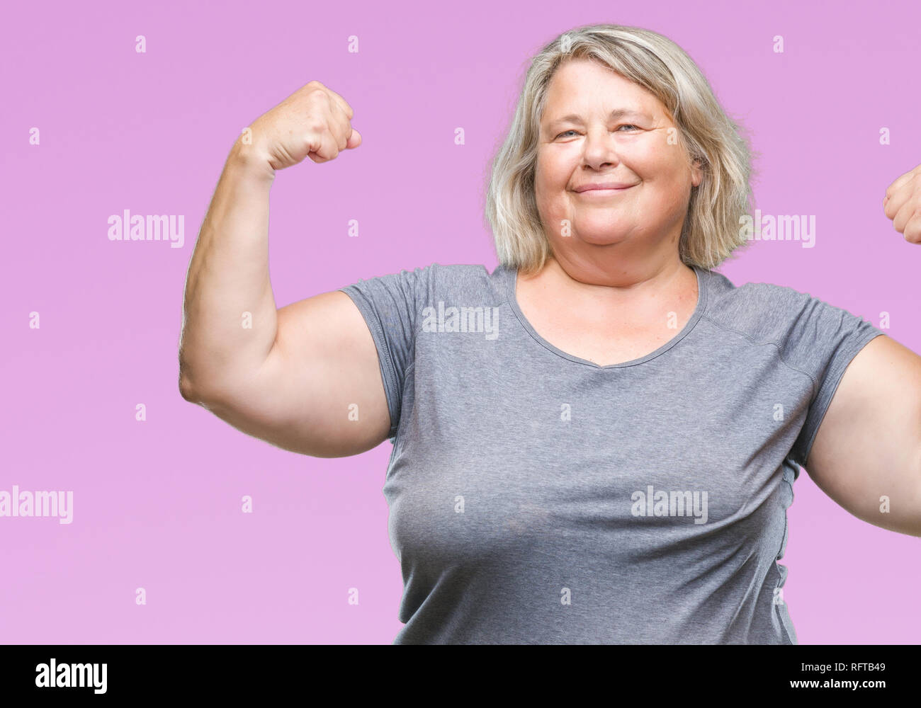 Senior plus size caucasian woman over isolated background showing arms