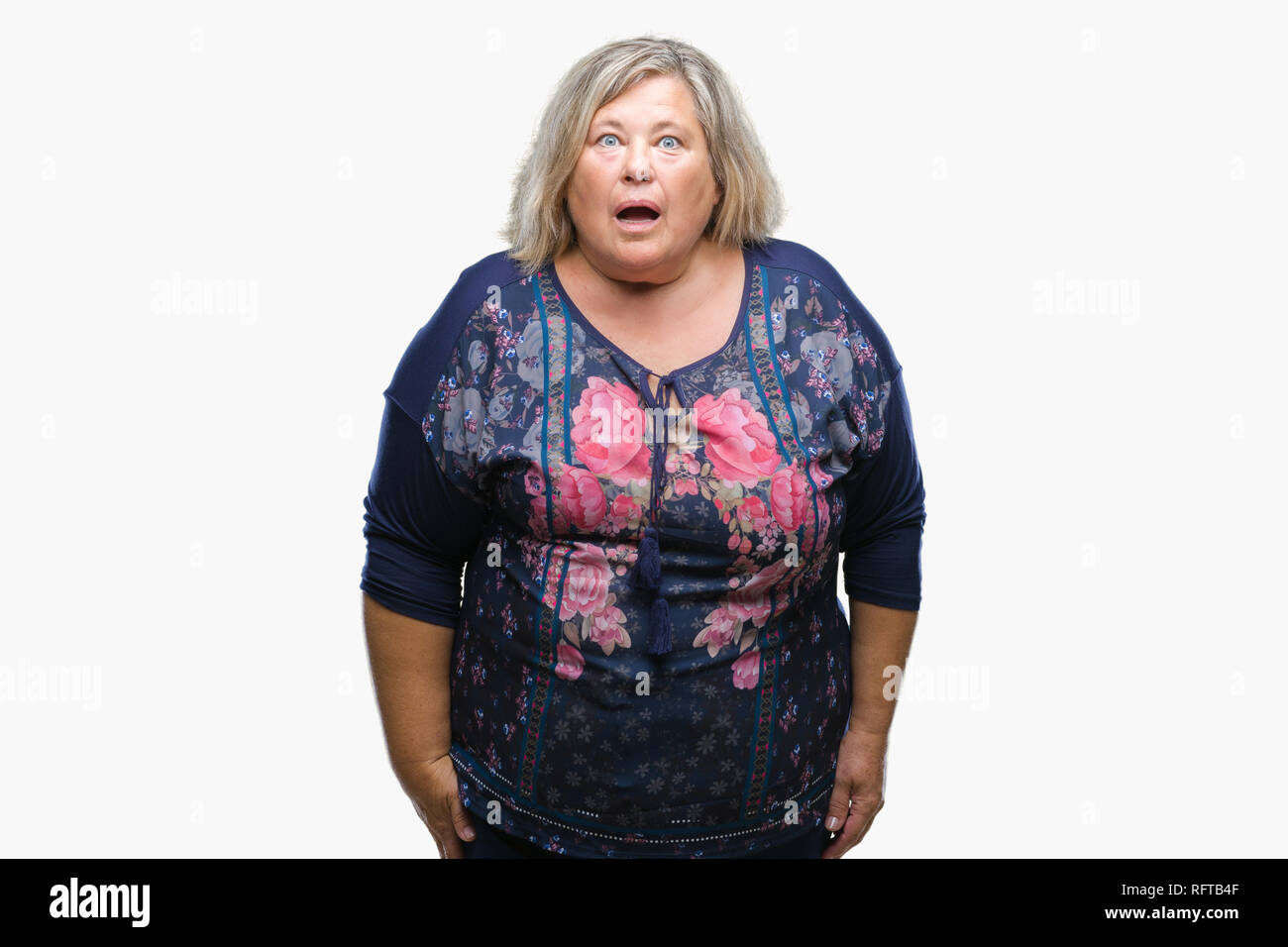 Senior plus size caucasian woman over isolated background afraid and shocked with surprise expression, fear and excited face. Stock Photo