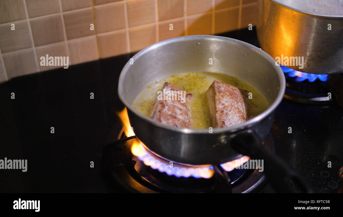 cordon blue fried in oil in a frying pan. Chicken cordon bleu frying in