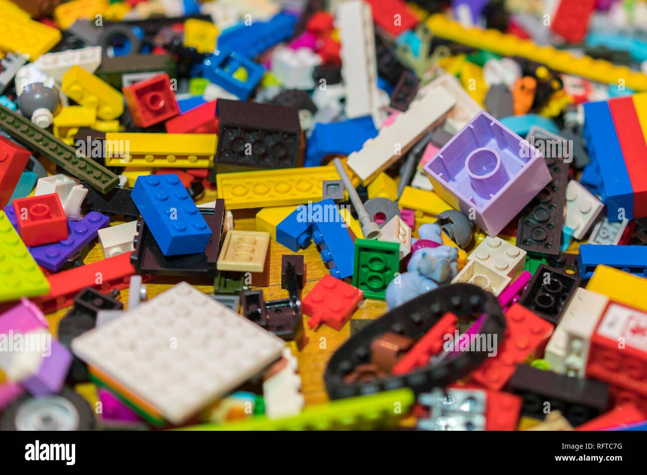 Close up of colorful plastic bricks on the floor. Early learning. Children's plastic constructor on the floor. background Stock Photo