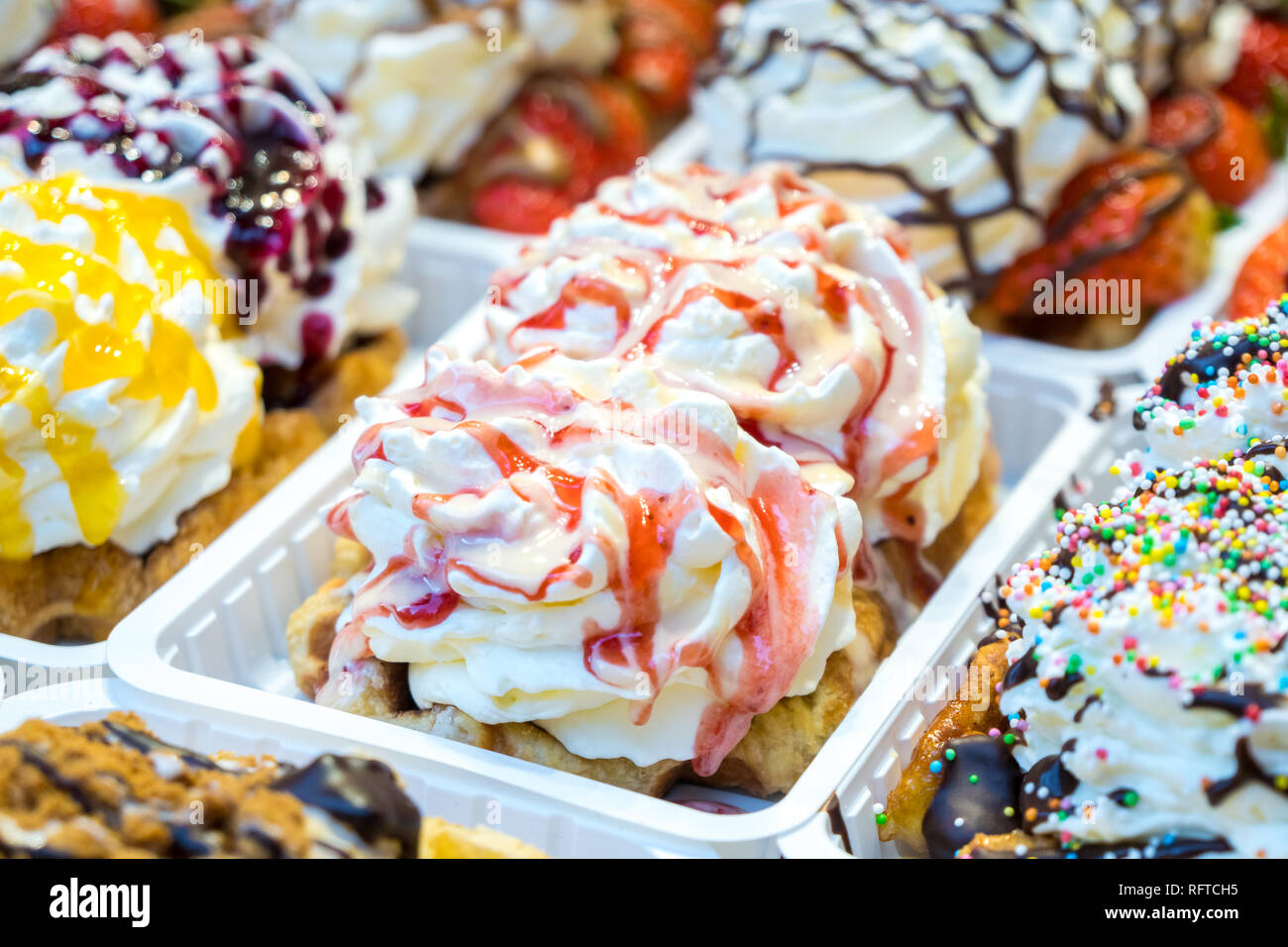 colorful cake sweet dessert with whipped cream at a street food market