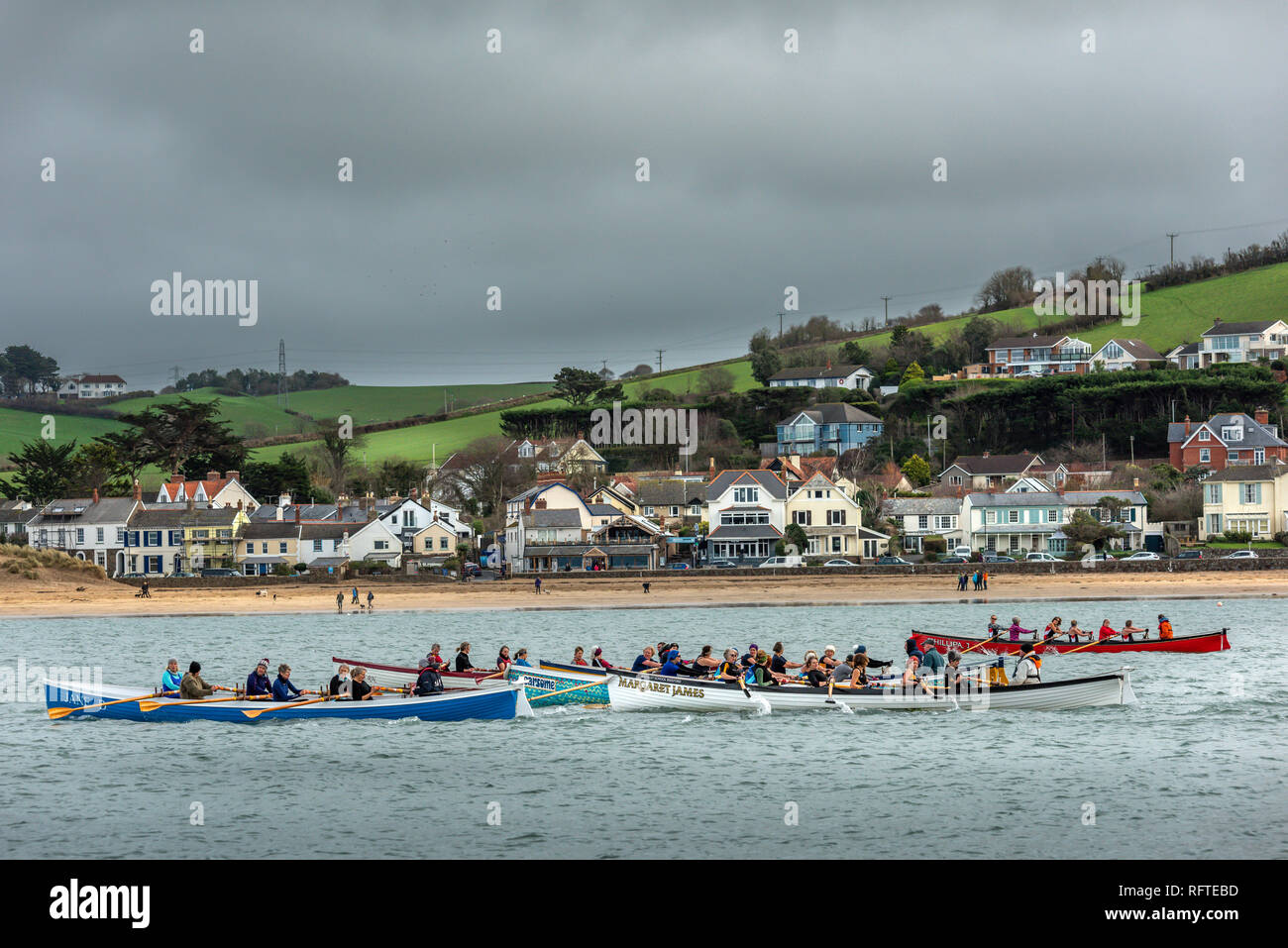 UK Weather - Saturday 26th January. On a cold overcast day in North Devon, Pilot Gig Boats gather at the quayside in the village of Appledore to do battle in the 'North Coast Gig League Series' on the River Torridge. Stock Photo