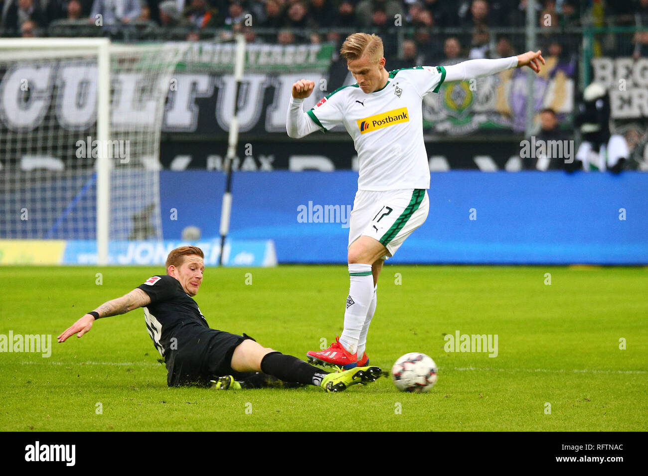 Moenchengladbach, Germany. 26th Jan, 2019. Andre Hahn (L) of Augsburg vies with Oscar Wendt of Moenchengladbach during the Bundesliga match between Borussia Moenchengladbach and FC Augsburg in Moenchengladbach, Germany, Jan. 26, 2019. Moenchengladbach won 2-0. Credit: Ulrich Hufnagel/Xinhua/Alamy Live News Stock Photo