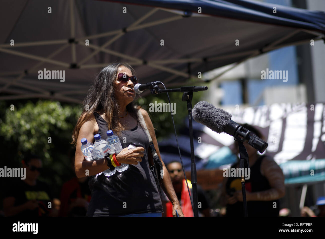 Brisbane, Queensland, Australia. 26th Jan, 2019. Elder Auntie Deb asks the crowd ''I want you to Google this lady's name. This lady's name is Pearl Gibbs. This lady was the one single aboriginal activist in our country and January 26, 1938 she was the one woman who walked into the great hall in Sydney for our rights.''.On the 26th of January, many Australians celebrate Australia day, but to many indigenous Australian people, it is a day synonymous with decades of systematic abuse and genocide. Several thousand protesters took the streets in Brisbane (known as Meanjin by local indigenous pe Stock Photo