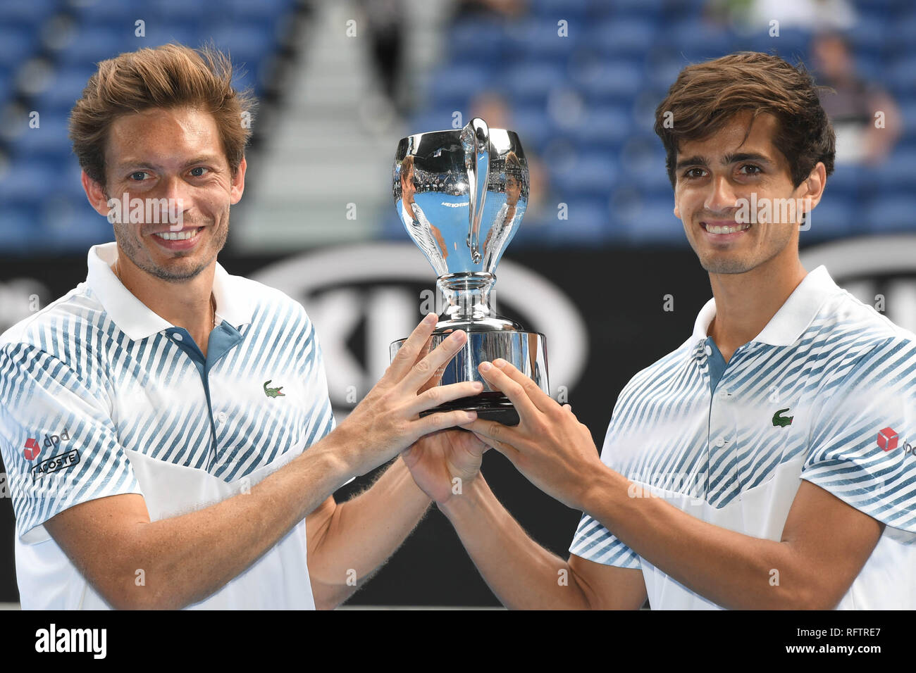 Melbourne, Australia. 27th Jan, Herbert(R)/Nicolas Mahut poses with the trophy during the trophy ceremony for the men's doubles final match between Pierre-Hugues Herbert/Nicolas Mahut of France and Kontinen(Finland)/John ...