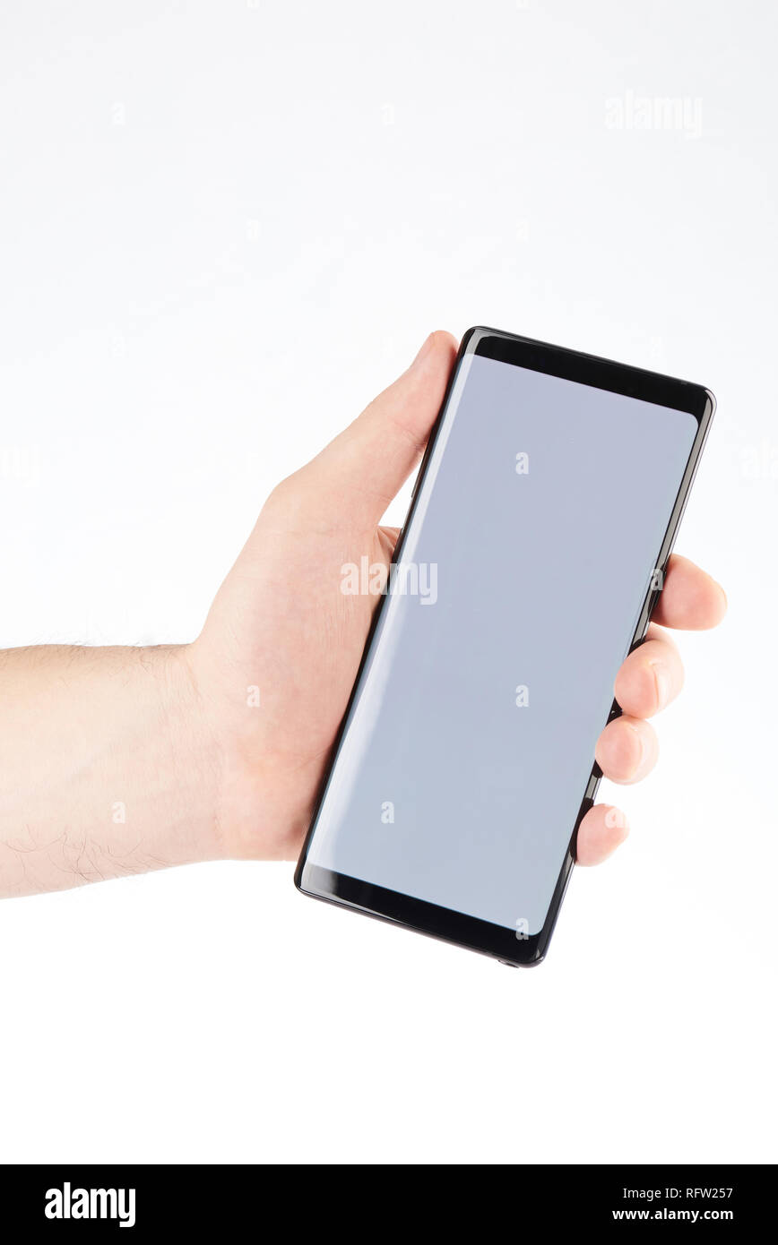 Modern smartphone in hand isolated on white background Stock Photo - Alamy