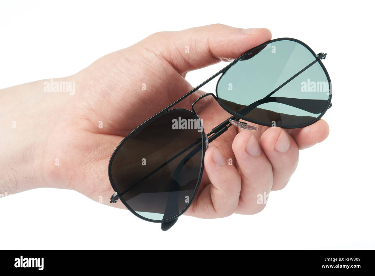 Close-up of sun protecting glasses in hand isolated on white background Stock Photo