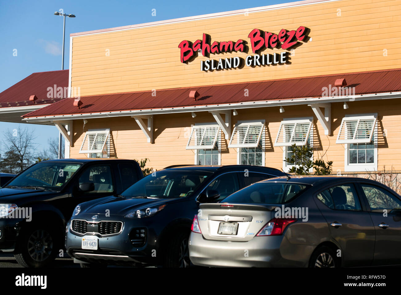 A logo sign outside of a Bahama Breeze restaurant location in