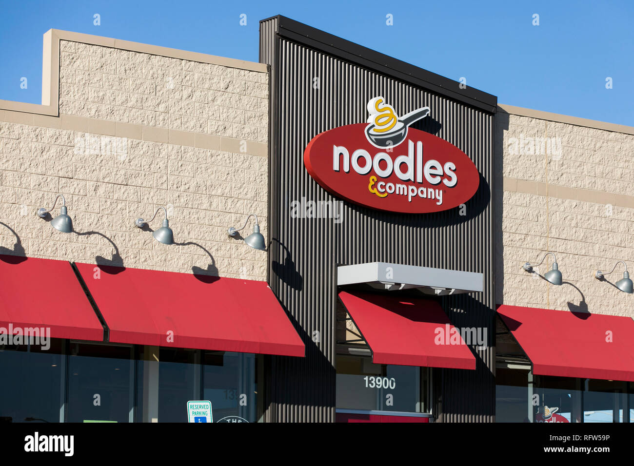 A logo sign outside of a Noodles & Company restaurant location in Woodbridge, Virginia, on