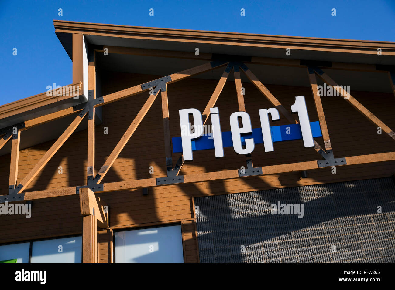 A logo sign outside of a Pier 1 Imports Inc., retail store in