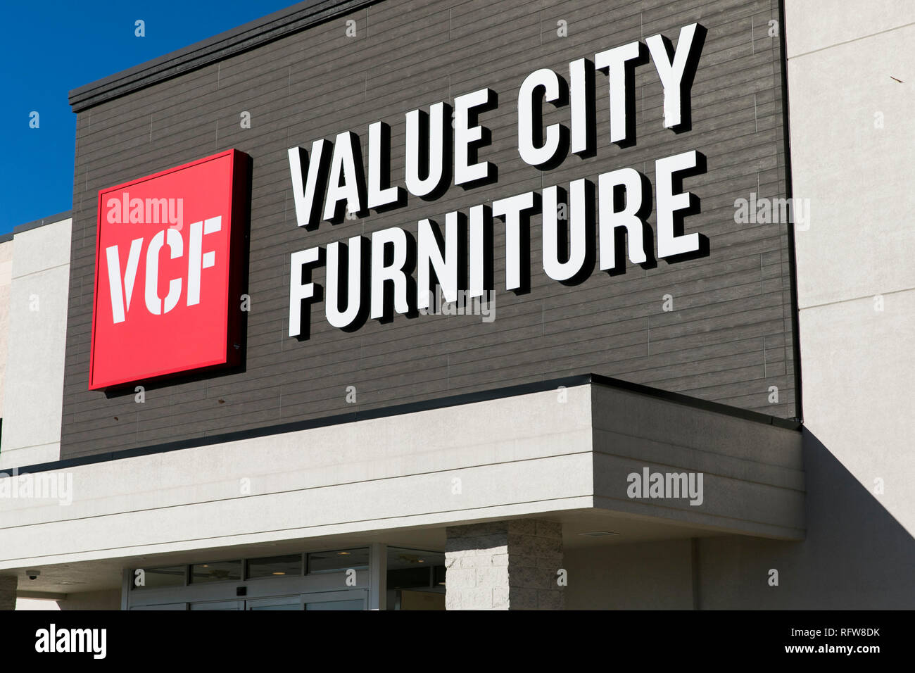 A Logo Sign Outside Of A Value City Furniture Retail Store
