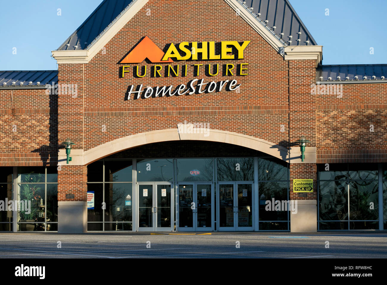 A Logo Sign Outside Of A Ashley Furniture Homestore Retail Store