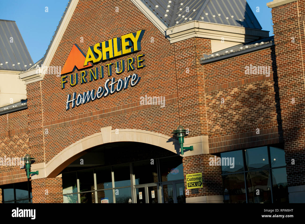 A Logo Sign Outside Of A Ashley Furniture Homestore Retail Store