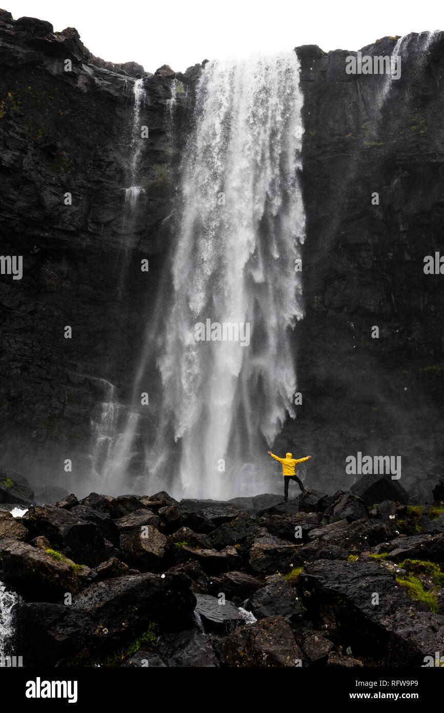 Hiker at Fossa waterfall, Streymoy island, Faroe Islands, Denmark, Europe Stock Photo