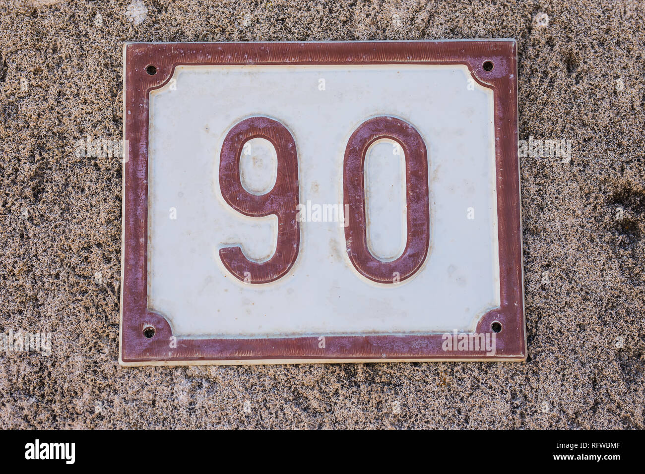 House number plate with number ninety 90 close-up Stock Photo