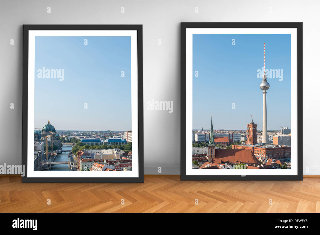 two framed pictures of Berlin skyline on wooden floor white wall background Stock Photo