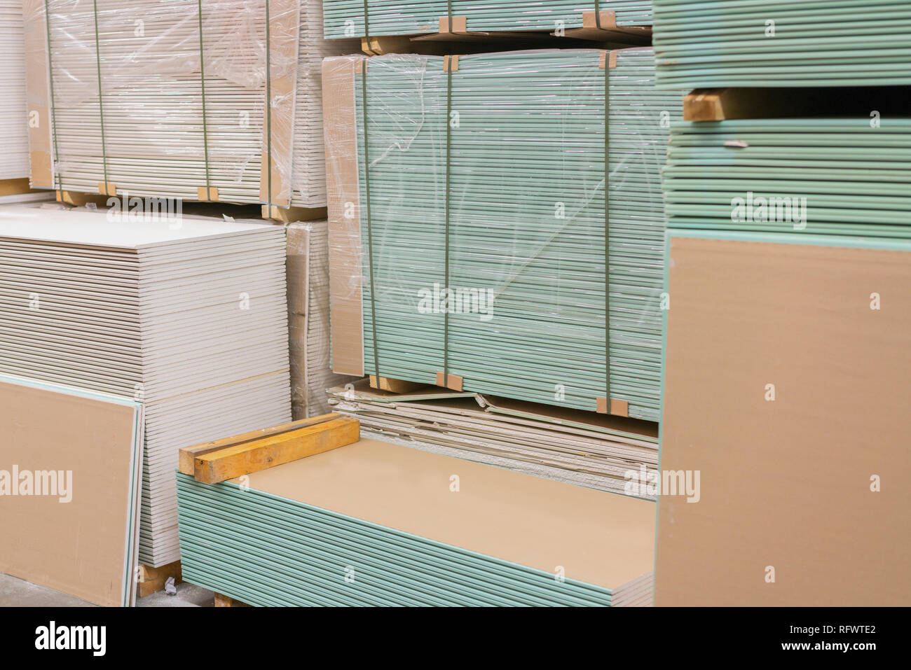 Gypsum plasterboard in the pack. The stack of gypsum board preparing